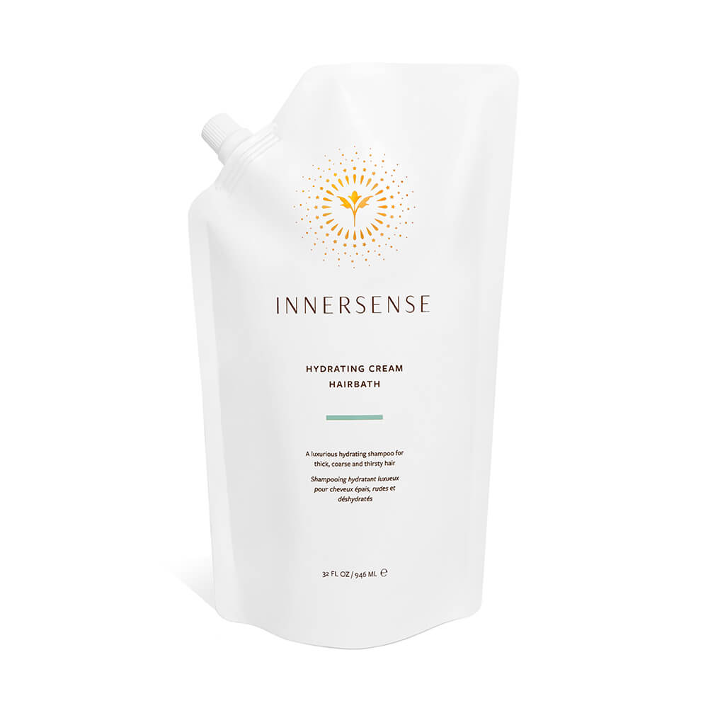 White bottle of innersense hydrating cream hairbath against a plain background.